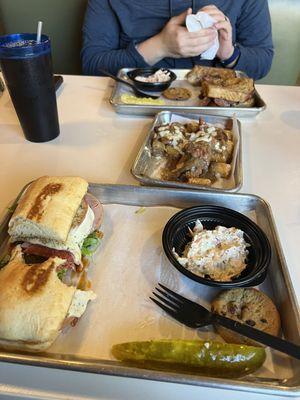 Italian sandwich, Reuben sandwich, pastrami poutine tots. Slaw, pickle, and cookie