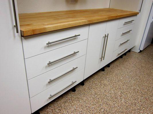 White cabinets, butcher block counter, garage fx epoxy floor