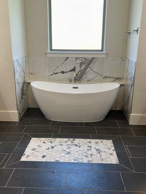 Stone inlay with standalone tub and backsplash