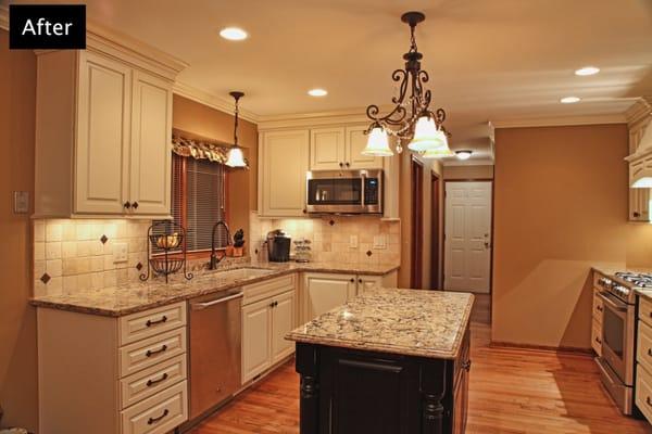 French Country inspired kitchen with painted white cabinets and Cambria quartz tops.