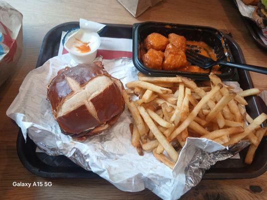 This is a saucy nuggets. French fries. Cheeseburger on a tray