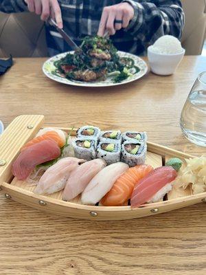 Sushi & sashimi along with crispy duck in the background