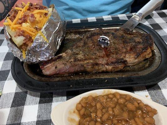 Ribeye with baked potato and baked beans