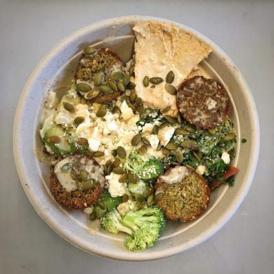 Build your own bowl: brown rice, avocado, almond dip, kale tabouleh, broccoli, falafel, pepitas, and lemon tahini