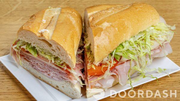 Italian Hero- Ham Salami, Provolone, Lettuce, Tomato, O.V, Salt, Black Pepper and Oregano on a Long Roll