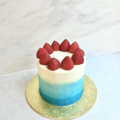 Vanilla cake with home made strawberry filling and fresh strawberry crown.