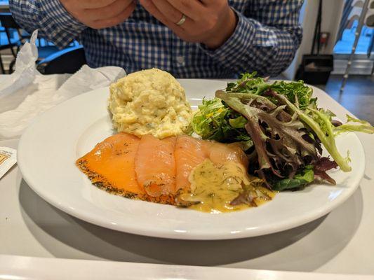 Smoked salmon platter with potato salad and greens