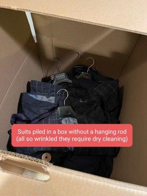 Suits piled in wardrobe box without hanging rod