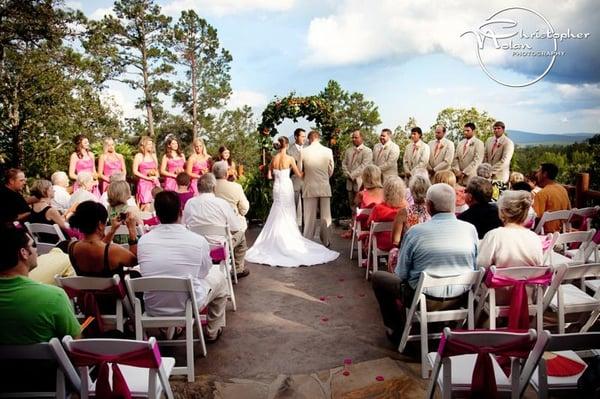 Bride and Groom say their vows.  120 white wedding chairs included in venue rental.  Pinnacle mountain backdrop - little rock