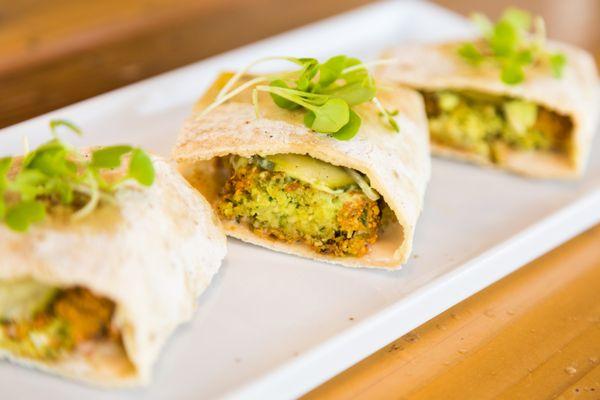 Falafel sliders with avocado pureé, tahini, pickled cucumber & shallots.