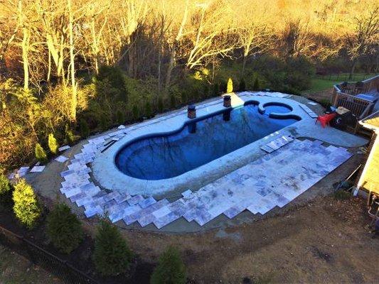 Travertine surround fiberglass swimming pool