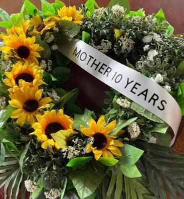 Memorial wreath for a mother with seven children, each sunflower represents a child. We are able to work closely with each customer