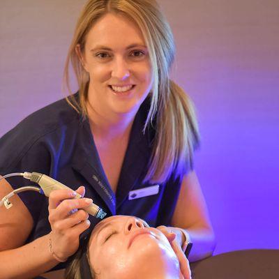 Our Esthetician, Hilary, performing Hydrafacial.