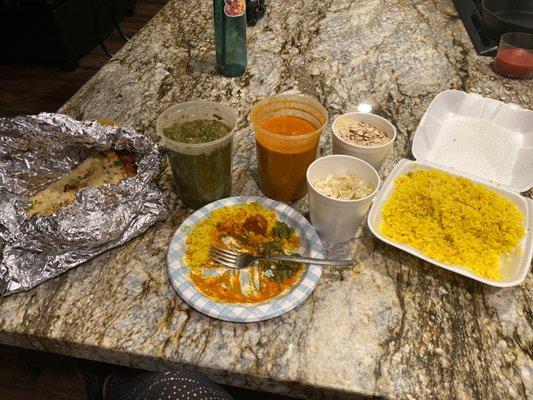 Family meal: spinach and chicken tikki masalla, 2types naan, rice, cabbage salad and dessert. Generous portions, amazing flavor!