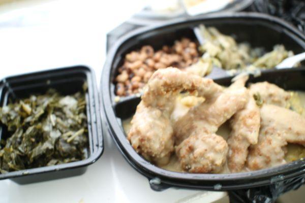 Smothered wings with sides and an extra portion of greens.