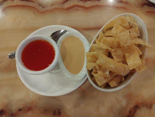 Crispy wonton chips with sweet and sour sauce and spicy mustard.