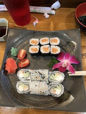 Salmon roll on top and Philadelphia roll on the bottom with miso soup in the corner.