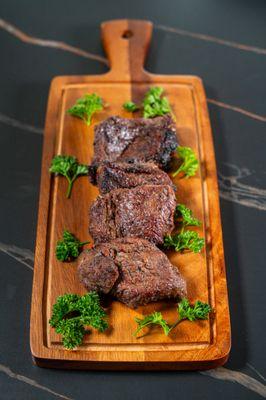 A tender cut of Coulotte steak, marinated with a special garlic mixture to order.