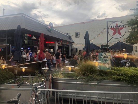 Ernies outside patio seating surrounded by food trucks.