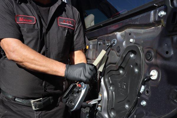 Moises fixing window on vehicle.