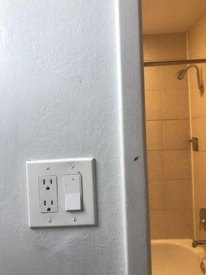 Filthy wall and non gfci outlet by the bathroom sink