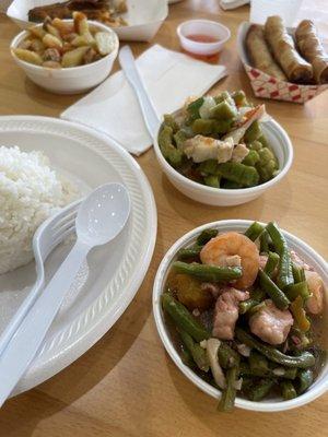 Closer shot of veggies, rice and mini egg roll