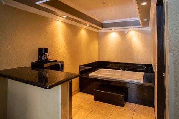 Lighted Jacuzzi Nestled Around Black Granite