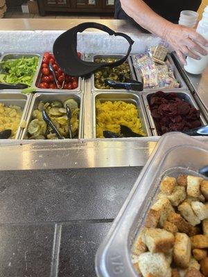 woman drops hat in salad bar, proceeded to leave it there until we told someone