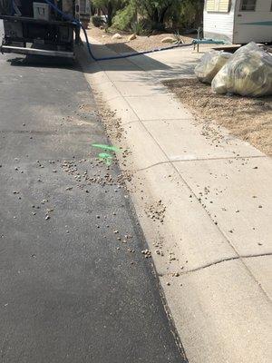 Gravel mess in street and in front of neighbor's house.