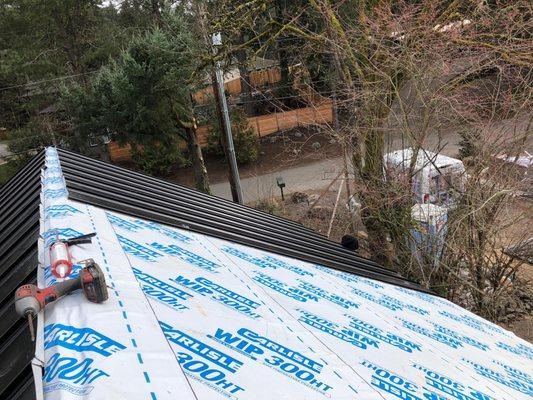 Home in Lake Oswego getting a new black metal roof.