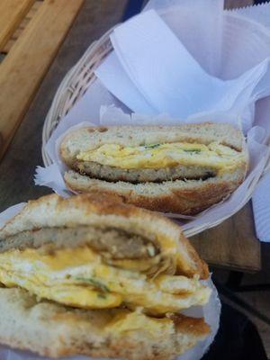 Breakfast sandwich bun with sausage, egg, and cheese.