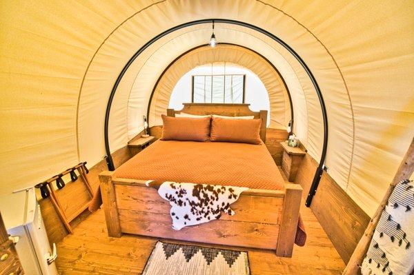 Experience Glamping at its best in the Wild, Wild West! Stay in one of our western-themed Conestoga Wagons.