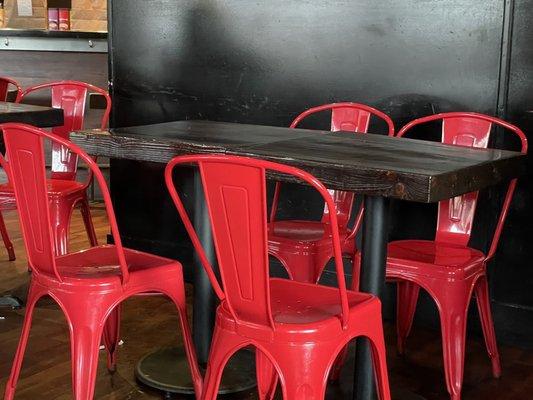 Wood topped tables with fire engine red metal chairs