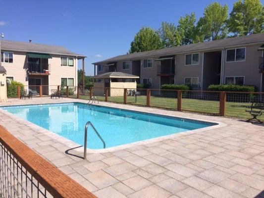 Pool after Graham Landscaping installed pavers and fence