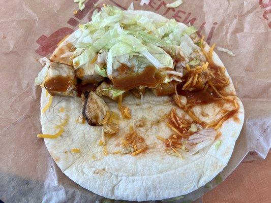 Chicken soft shell taco with hot sauce.