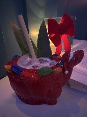 Mystery na cocktail in a christmasaurus mug