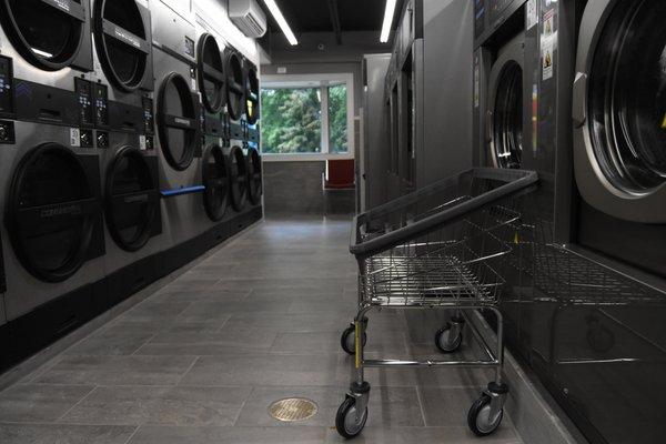 row of machines and laundry cart