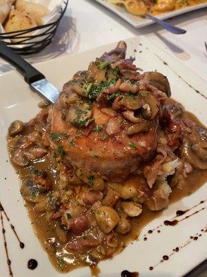 French pork chop over mashed potatoes, mushrooms garlic sun-dried tomatoes and balsamic