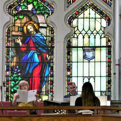 Vocalists rehearse in the choir loft