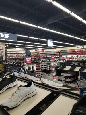 Work, sneakers, slip-ons, sandals, men's, ladies, kids and discount racks at the back.