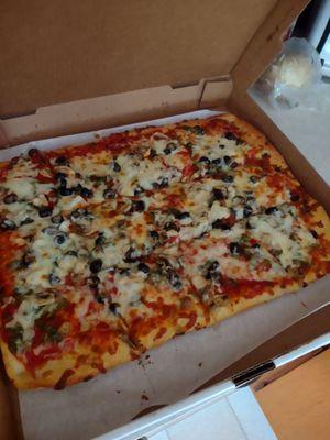 A Pizza with Green Peppers, Mushrooms and Olives. A 12 piece sheet pizza