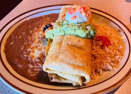 Chimichanga with guacamole and sour cream with beans and rice. Meal included soup or salad.