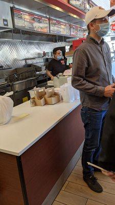 Employee improperly wearing mask while preparing food.