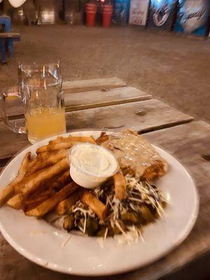 Blurry grapefruit radler with pork schnitzel plate with Brussels sprout salad and fries