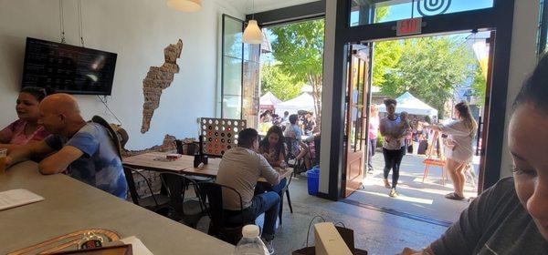 Open and illuminated storefront with views out into downtown Duluth, with Fall Festival making the view even better today.