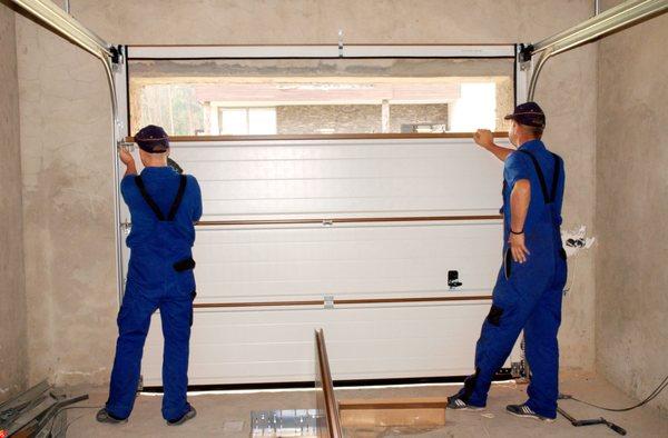 Our professional technicians at work on a new garage door install