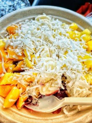 Tropical açaí bowl with mango, coconut, banana and pineapple