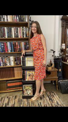 Model is wearing a Boden dress, and standing in our library