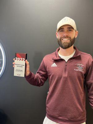 Kyle Moore holds up his top originator award from lending partner, Rocket Mortgage. Agave one of Rocket's top mortgage brokers.