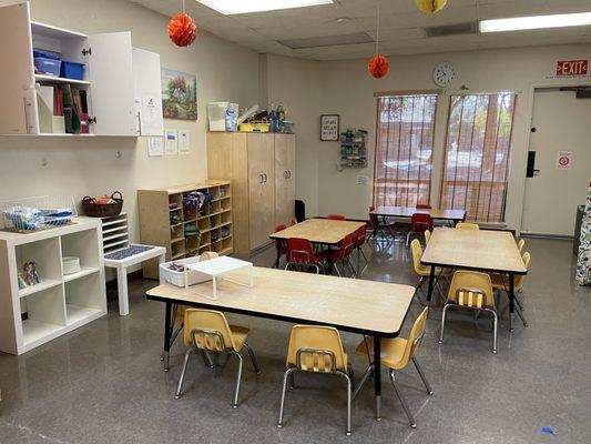 The Sunshine Lunchroom is a bright, cheerful space where children gather to enjoy their meals in a warm and welcoming atmosphere.